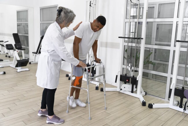 medical-assistant-helping-patient-with-physiotherapy-exercises